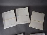 four pieces of paper with writing on them sitting on a table