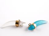 pair of turquoise and gold earrings on white background