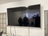 a large flat screen tv mounted on the wall in a room