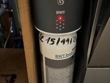 a black and white water heater in the corner of a room