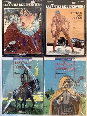 four books of comics are lined up on a white surface