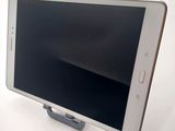 a tablet that is sitting on a stand on a table