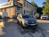 the car is parked in front of a building with cars parked in front of it