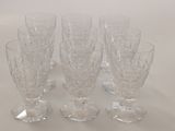 six wine glasses sitting on a table with a white background