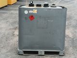 a large gray container with a red sticker on it