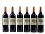 six bottles of wine are lined up on a white surface