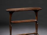 an old wooden table with a shelf on top of it