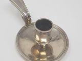 a silver saucer with a spoon on top of it