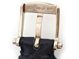 a black leather belt with a gold buckle on a white background