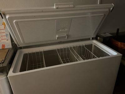 a white chest freezer sitting in a kitchen