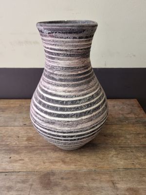 a vase that is sitting on a wooden table