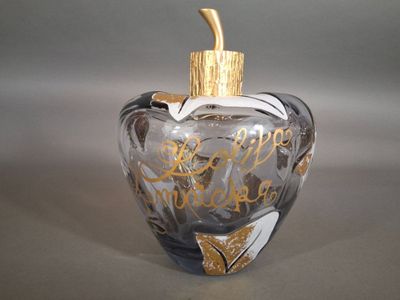 a glass bottle with a gold top and a gold cap