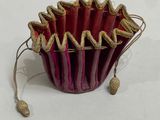 a red and gold cupcake holder on a white table