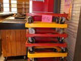 a stack of red, yellow, and red carts in a store