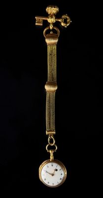 an image of a close up of a gold watch on a black background