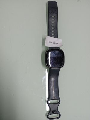 a watch that is hanging on a wall with a tag attached to it