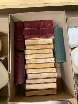 many books in the box on the table