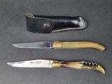 three different types of knives on a table with a leather sheath