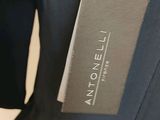 a close up of a suit with a tag on it