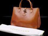 a brown bag and a white towel on a black background