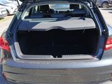 the back of a car with its trunk open in a parking lot
