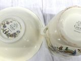 a cup and saucer sitting on a white cloth