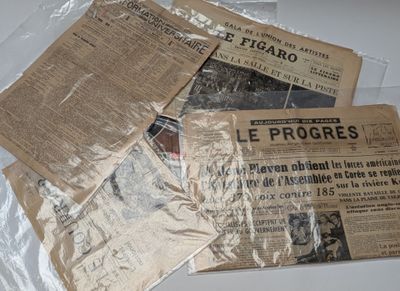 a pile of newspapers sitting on top of a table