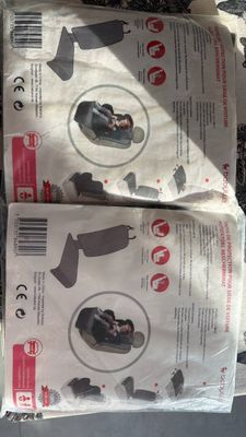 two packages of baby car seats on the ground