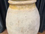 a large white vase sitting on a wooden table