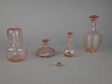 five different glass vases sitting on a table