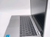 a silver laptop computer sitting on top of a white table