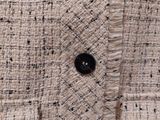 close up of a white and black jacket with a black button
