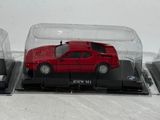 three model cars in a display case on a table