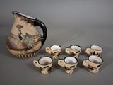 six cups and a pitcher sitting next to each other on a table
