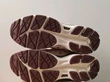 the soles of a pair of running shoes on top of a cardboard box