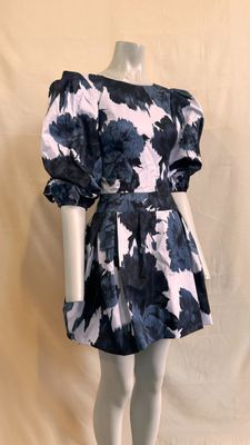 the mannequin is wearing a black and white floral print dress