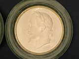 two coins in a glass bowl on a black surface