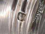 a close up of a metal object with a hole in it
