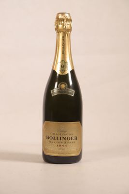 the bottle of champagne is sitting on a white surface