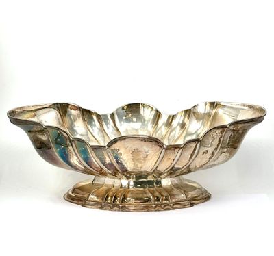 a silver bowl on a stand on a white surface