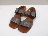 the sandals are made of leather and are decorated with a bow