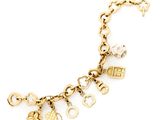 a close up of a gold bracelet with charms on it