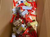 a cardboard box filled with assorted items like toothbrushes, toothpaste, toothpaste, toothpaste, and toothpaste