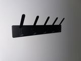 a picture of a wall mounted coat rack with five hooks