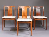 three wooden chairs sitting next to each other on a gray surface