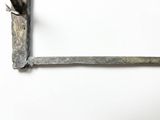 a picture of a piece of metal with a plant growing out of it