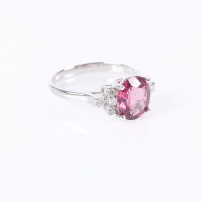 a pink tourmaline and diamond ring on a white background