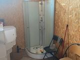 une salle de bains équipée d'une douche et d'une chaise