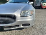 a silver car that is parked in a parking lot