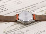 a watch sitting on top of a piece of paper